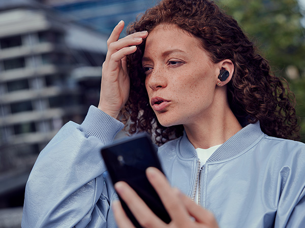 Woman enjoying crystal call feature of Philips headphones